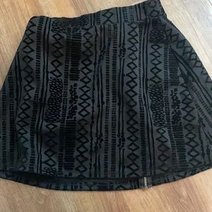 Suede black mini skirt with patterns